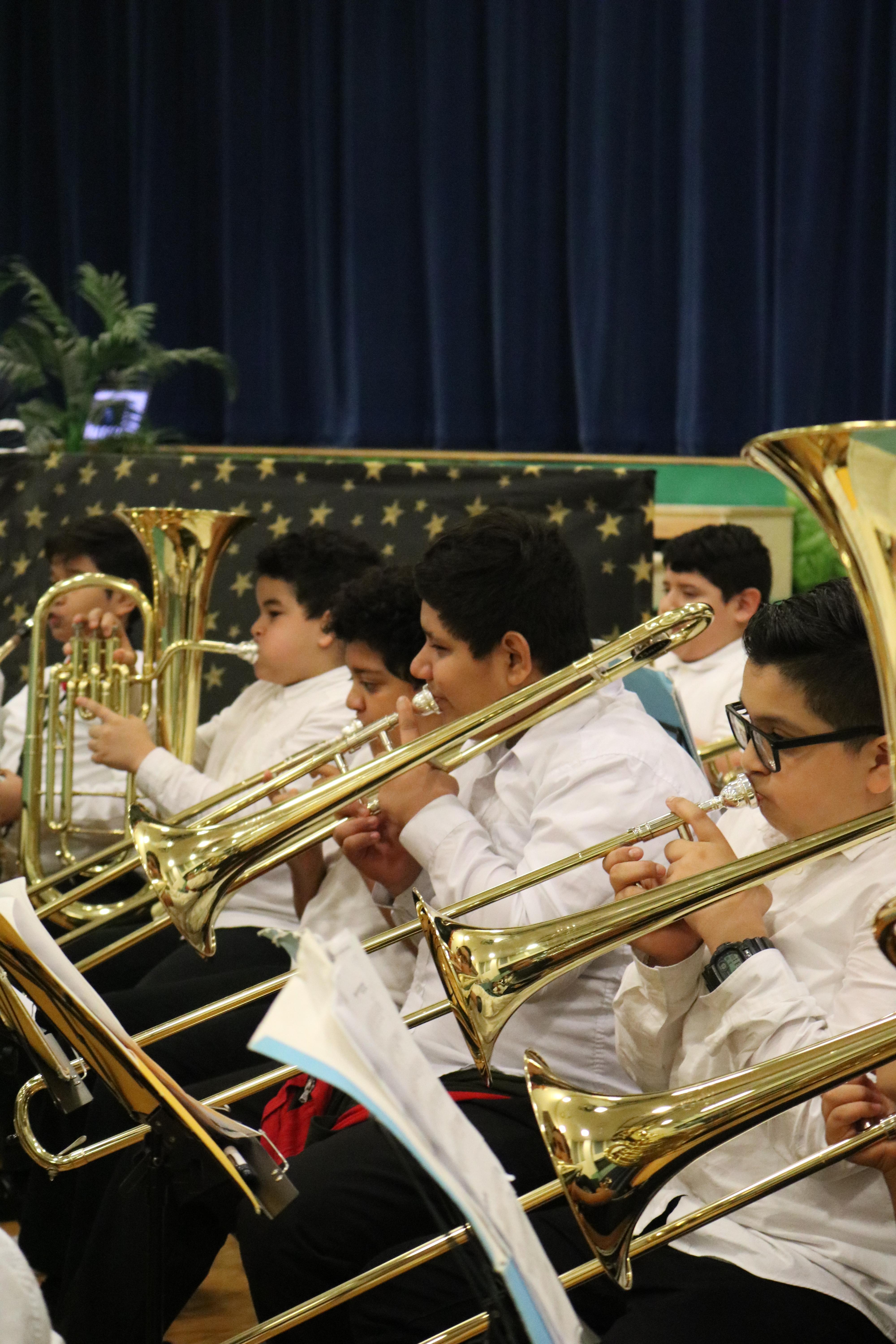 close up of the kids playing the trumpet and the tuba