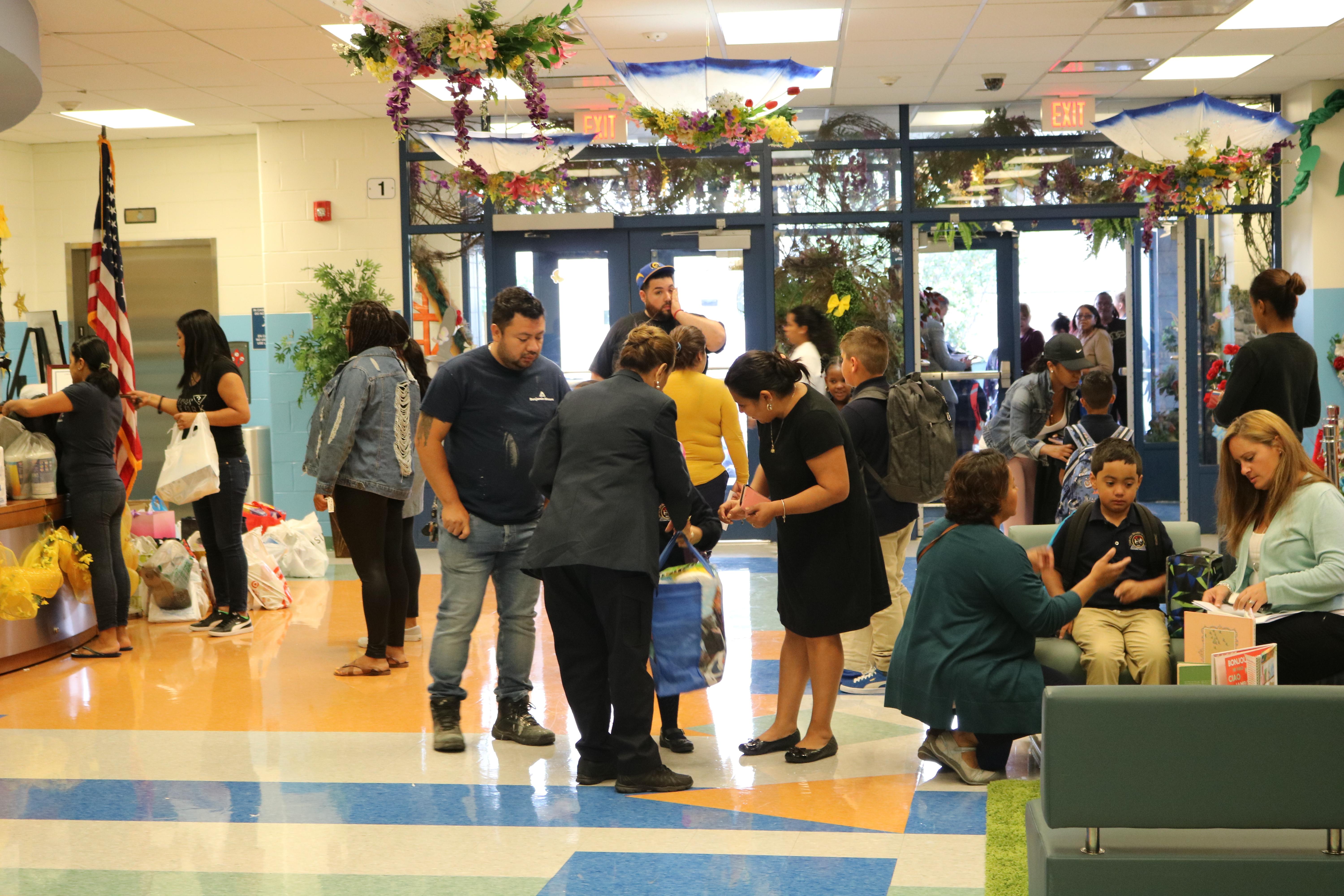 school entryway with parents, students, and staff