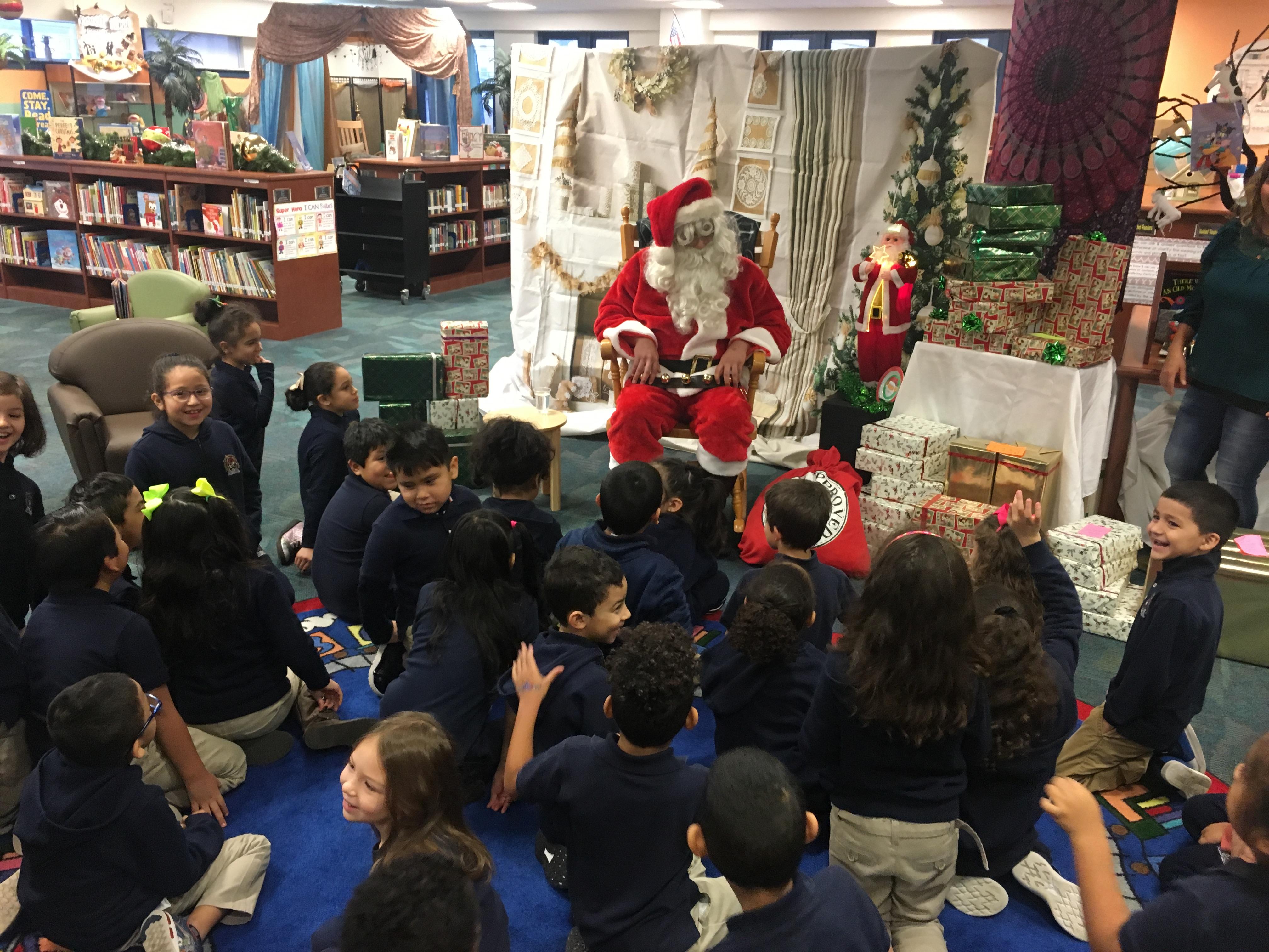 Santa Andrew seated with students